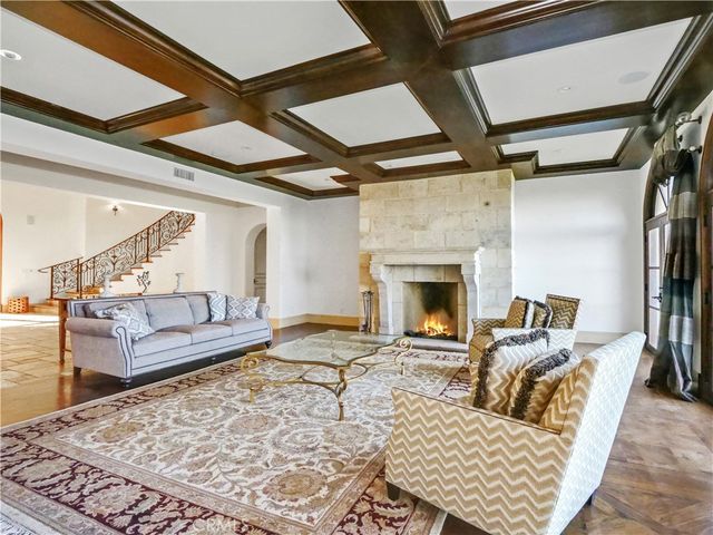 a kitchen with granite countertop a stove a sink dishwasher a dining table and chairs with wooden floor