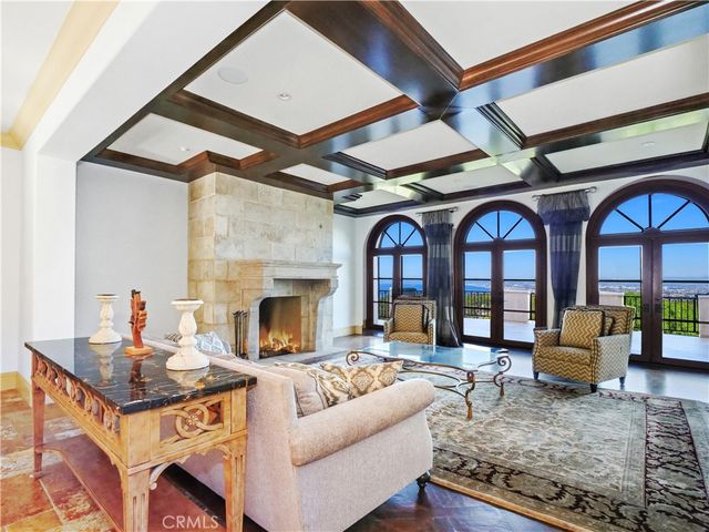 a bathroom with a granite countertop sink a large mirror and a wooden floor