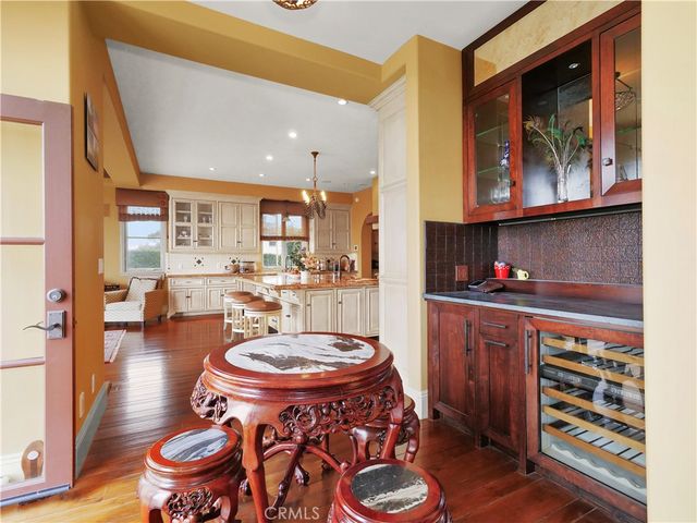 a kitchen with white cabinets and sink