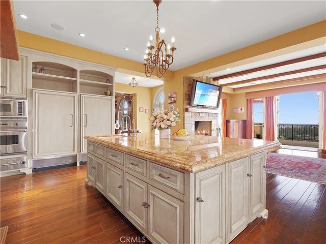 a living room with furniture a fireplace and flat screen tv
