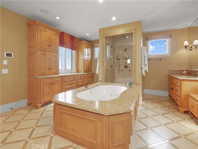 a spacious bedroom with a large bed and a chandelier