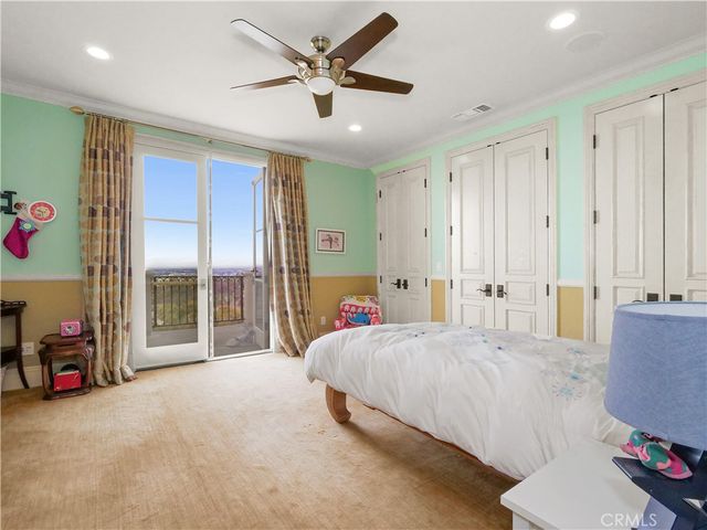 a bedroom with a bed couch and window