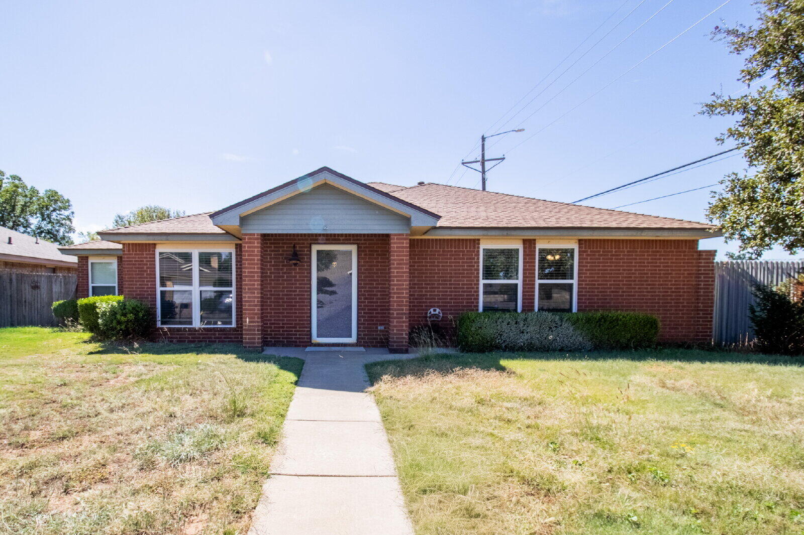 5731 95th Street Lubbock, TX 79424 - Photo 16 of 30 a front view of a house with garden