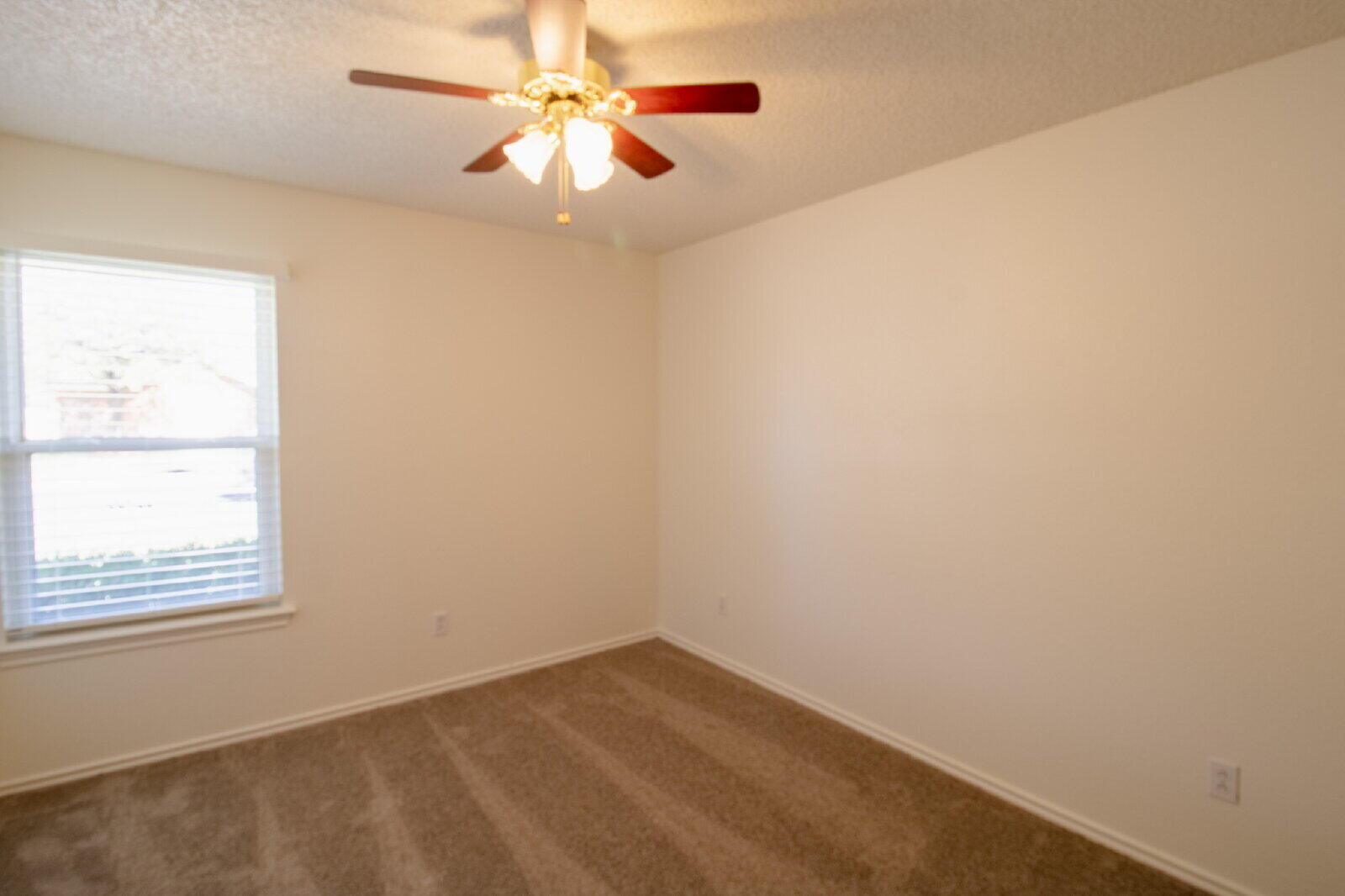 5731 95th Street Lubbock, TX 79424 - Photo 28 of 30 an empty room with a window and a fan