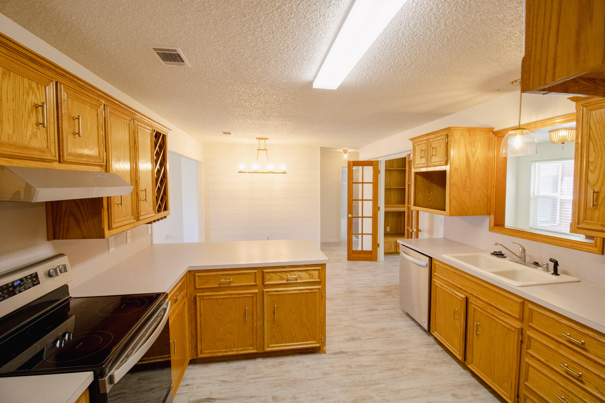 5731 95th Street Lubbock, TX 79424 - Photo 7 of 30 a kitchen with stainless steel appliances granite countertop a sink and cabinets