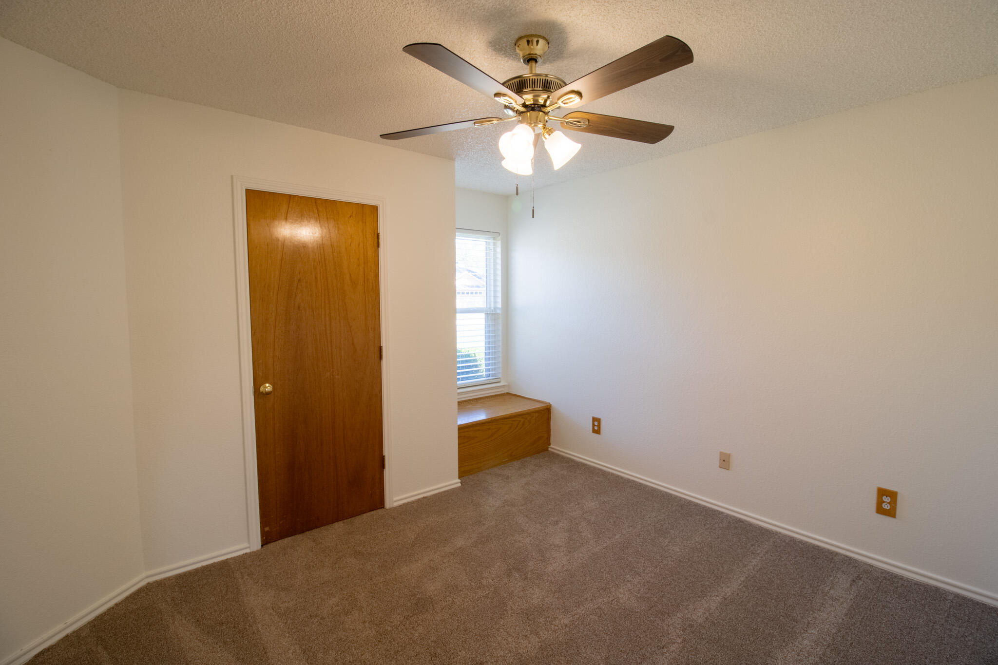 5731 95th Street Lubbock, TX 79424 - Photo 9 of 30 an empty room with chandelier fan and windows