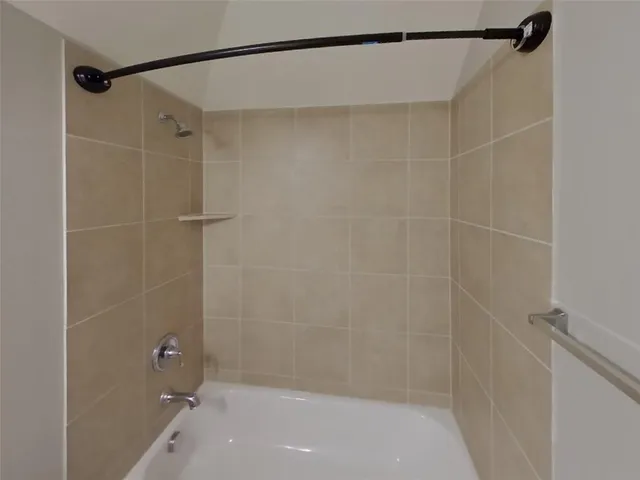 a bathroom with a shower and a shower