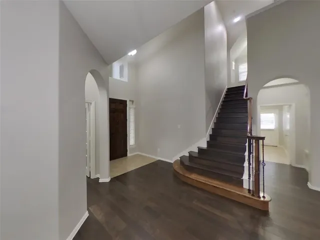 a view of entryway and hall with wooden floor
