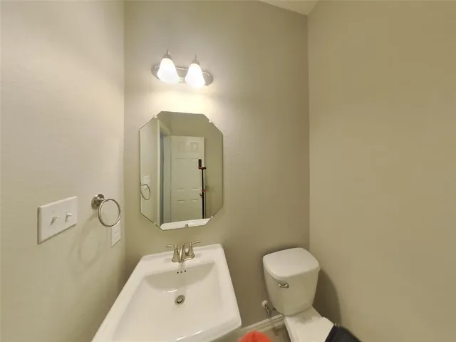 a bathroom with a toilet and a window