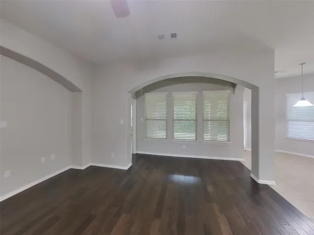 a living room with wooden floor and a fireplace