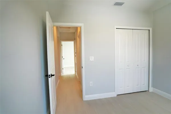 a view of a small space with wooden floor and a bathroom