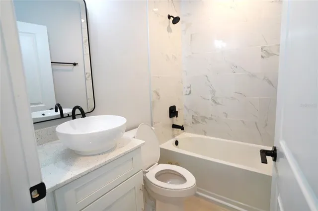 a bathroom with a sink a toilet and a bathtub