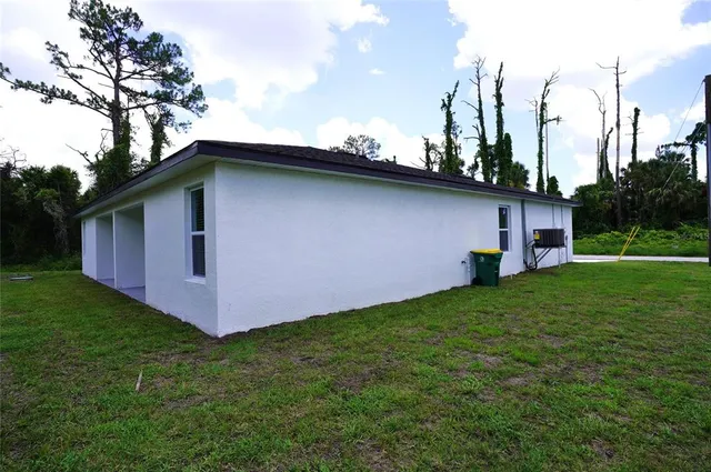 a front view of house with yard and trees