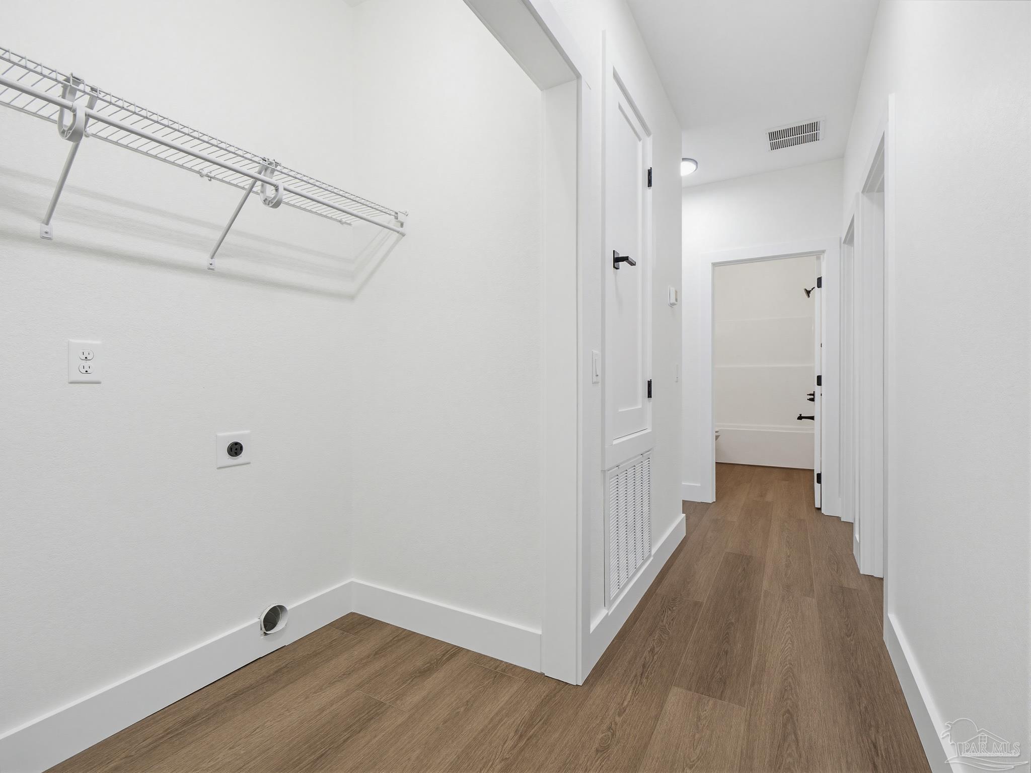 5724 Riviera Drive Milton, FL 32583 - Photo 38 of 52 a view of a hallway with wooden floor
