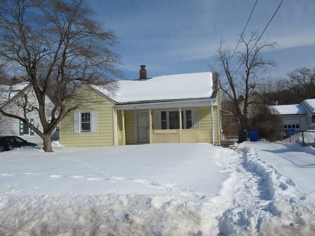 33 Connolly Street Springfield, MA 01151 - Photo 14 of 15 a front view of a house with a yard covered in snow
