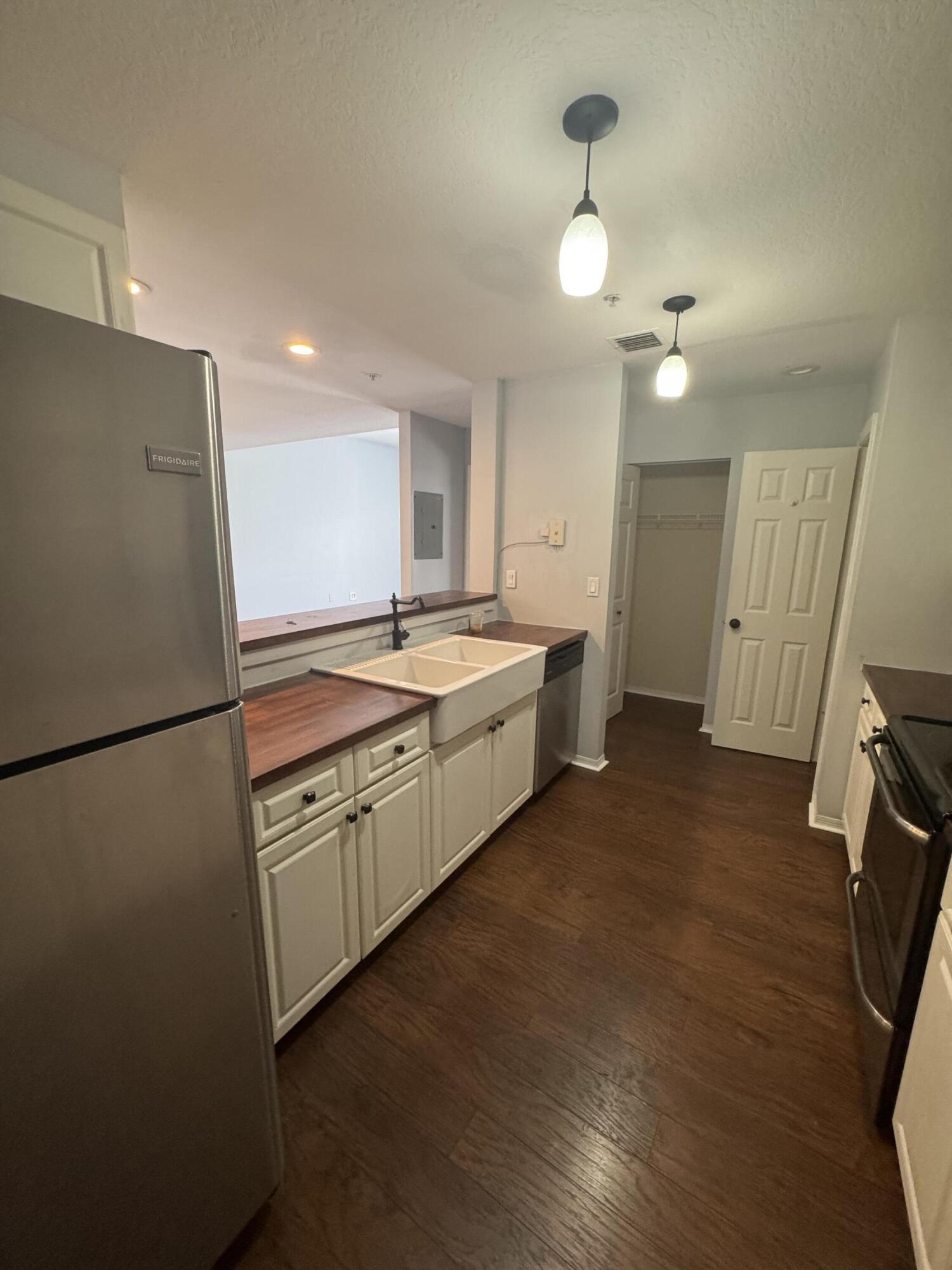 1200 Town Center Drive, Unit 426 Jupiter, FL 33458 - Photo 2 of 11 a kitchen with a refrigerator a sink and dishwasher