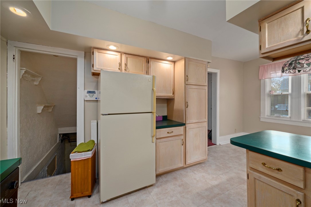 1589 Hampton Road Akron, OH 44305 - Photo 24 of 26 Kitchen with light brown cabinets, freestanding refrigerator, and dark countertops