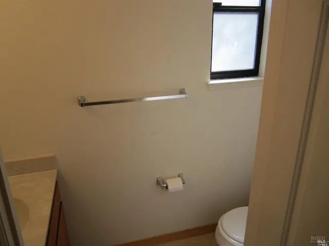a bathroom with a granite countertop sink a toilet and shower