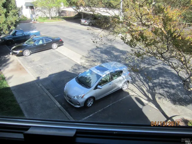 a view of a back yard from a balcony