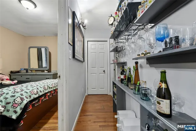 a view of a hallway with a livingroom with furniture and storage