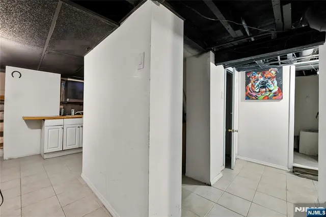 a view of storage and utility room with refrigerator and washer