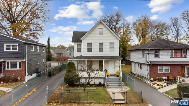 a front view of a houses on the roadside