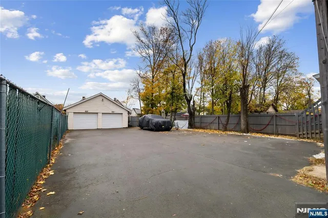 a view of a house with a yard and garage