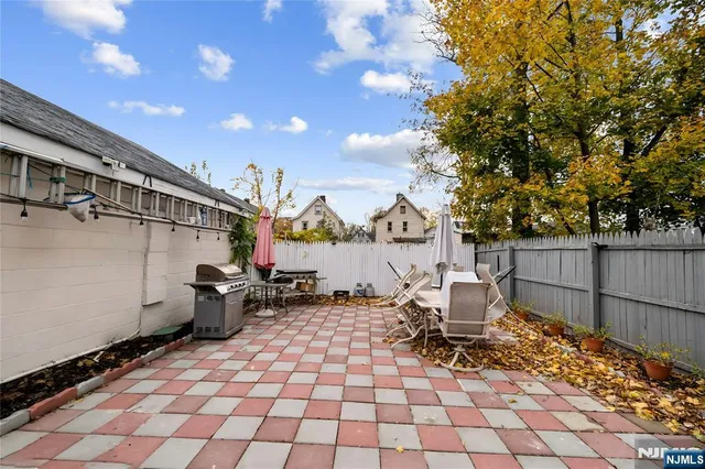 a view of a chairs and table in backyard