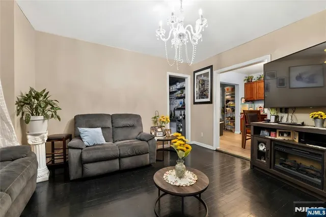 a living room with furniture and a chandelier