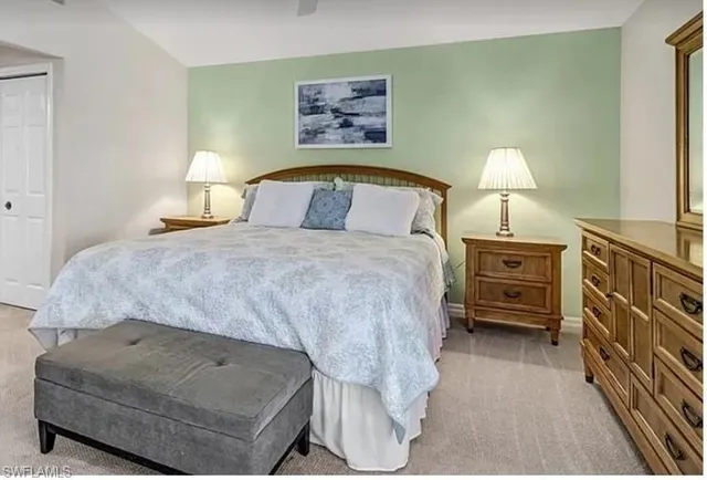 a bedroom with a bed and dresser