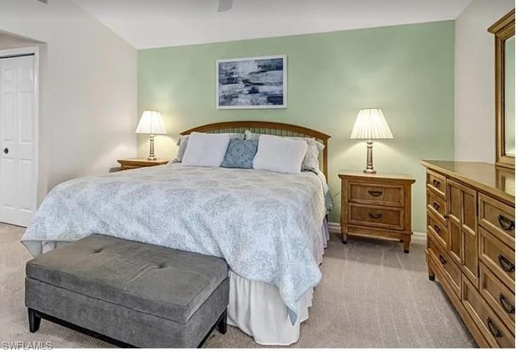 13060 Amberley Court, Unit 807 Bonita Springs, FL 34135 - Photo 11 of 33 a bedroom with a bed and dresser