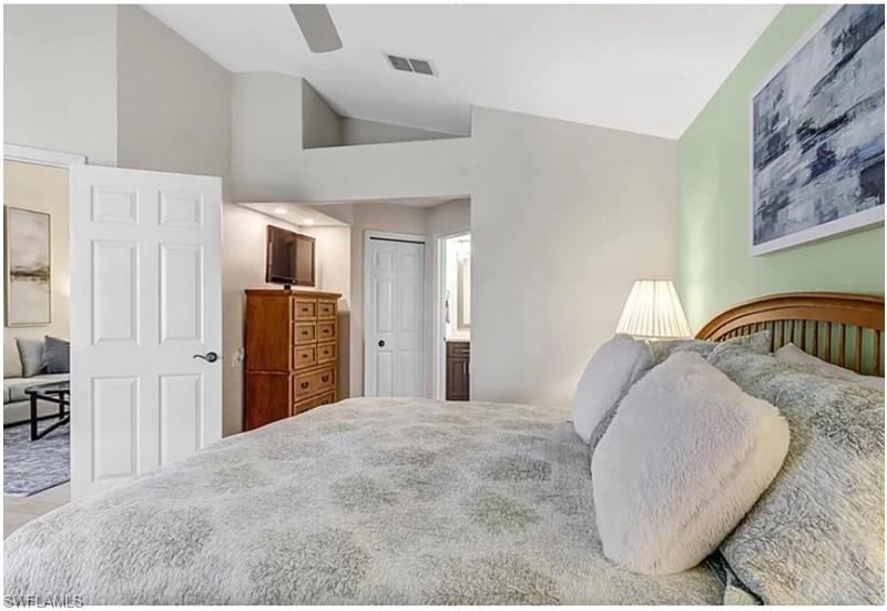 13060 Amberley Court, Unit 807 Bonita Springs, FL 34135 - Photo 12 of 33 a bedroom with a bed and a dresser