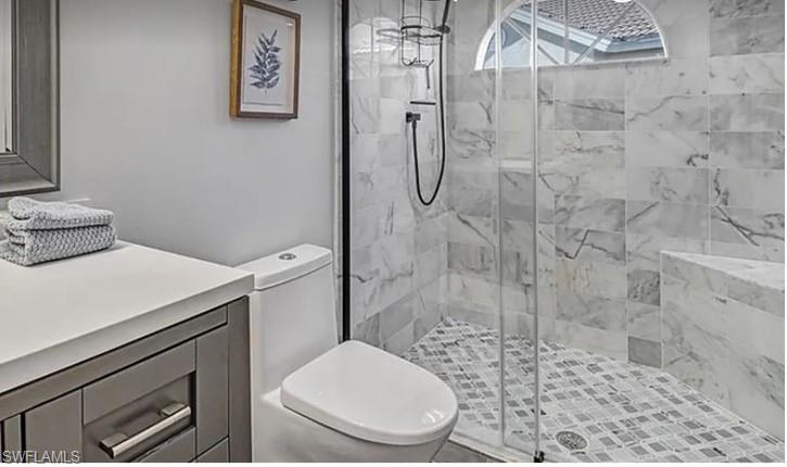 13060 Amberley Court, Unit 807 Bonita Springs, FL 34135 - Photo 13 of 33 a white toilet sitting next to a shower