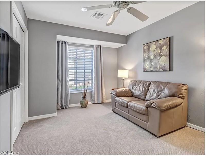 13060 Amberley Court, Unit 807 Bonita Springs, FL 34135 - Photo 14 of 33 a living room with furniture and a flat screen tv