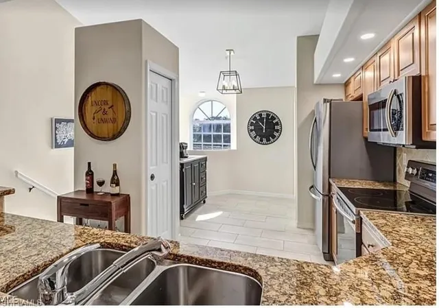 a kitchen with a refrigerator and a sink
