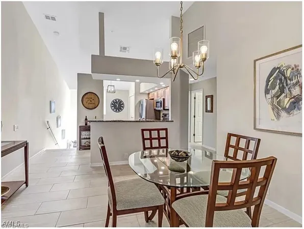 a view of a dining room with furniture and chandelier
