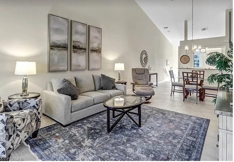 13060 Amberley Court, Unit 807 Bonita Springs, FL 34135 - Photo 8 of 33 a living room with furniture and wooden floor