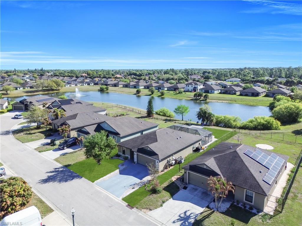 175 Shadowview Court Lehigh Acres, FL 33974 - Photo 32 of 39 Aerial view of residential area with a nearby body of water