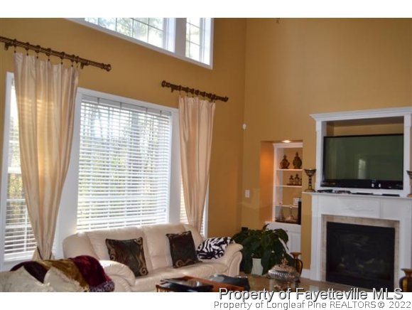 95 Falling Water Road Spring Lake, NC 28390 - Photo 4 of 20 a living room with furniture a flat screen tv and a fireplace