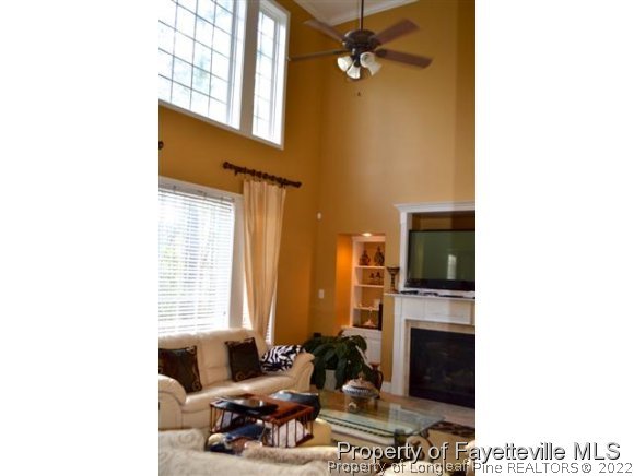 95 Falling Water Road Spring Lake, NC 28390 - Photo 5 of 20 a living room with furniture a fireplace and a flat screen tv