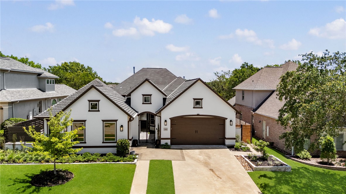 2833 Persimmon Ridge Court Bryan, TX 77807 - Photo 1 of 50 a front view of house with yard and green space