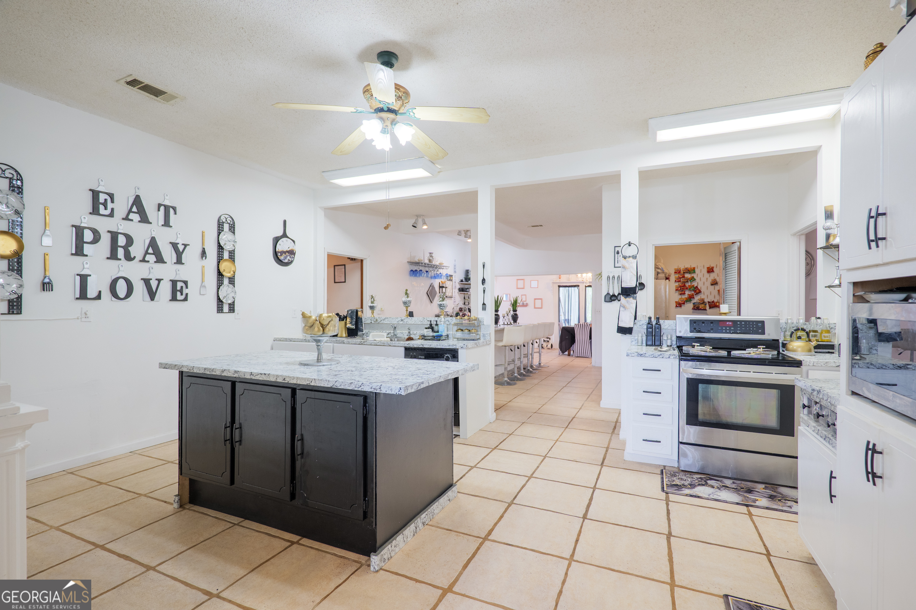 3473 Kay Circle Valdosta, GA 31606 - Photo 15 of 79 a kitchen with stainless steel appliances a stove sink and cabinets