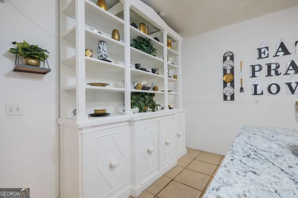 a view of a hallway with living room and furniture