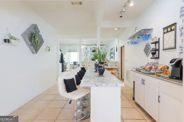 a living room with furniture a flat screen tv and a couch