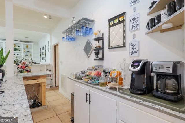 a bathroom with a double vanity sink a large mirror and shower