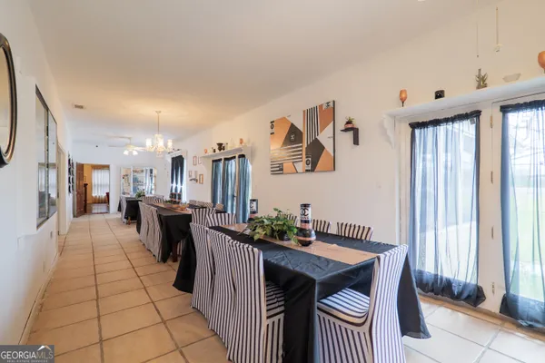 a bedroom with two beds and a chandelier