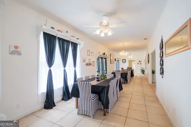 a bedroom with a bed and a lamp on table chair