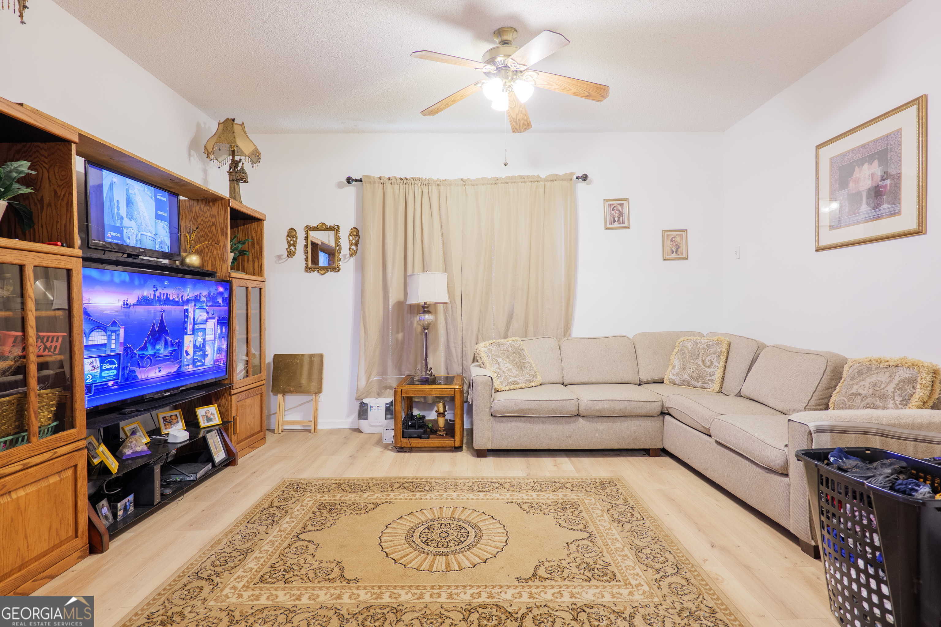 3473 Kay Circle Valdosta, GA 31606 - Photo 39 of 79 a living room with furniture a flat screen tv and a couch