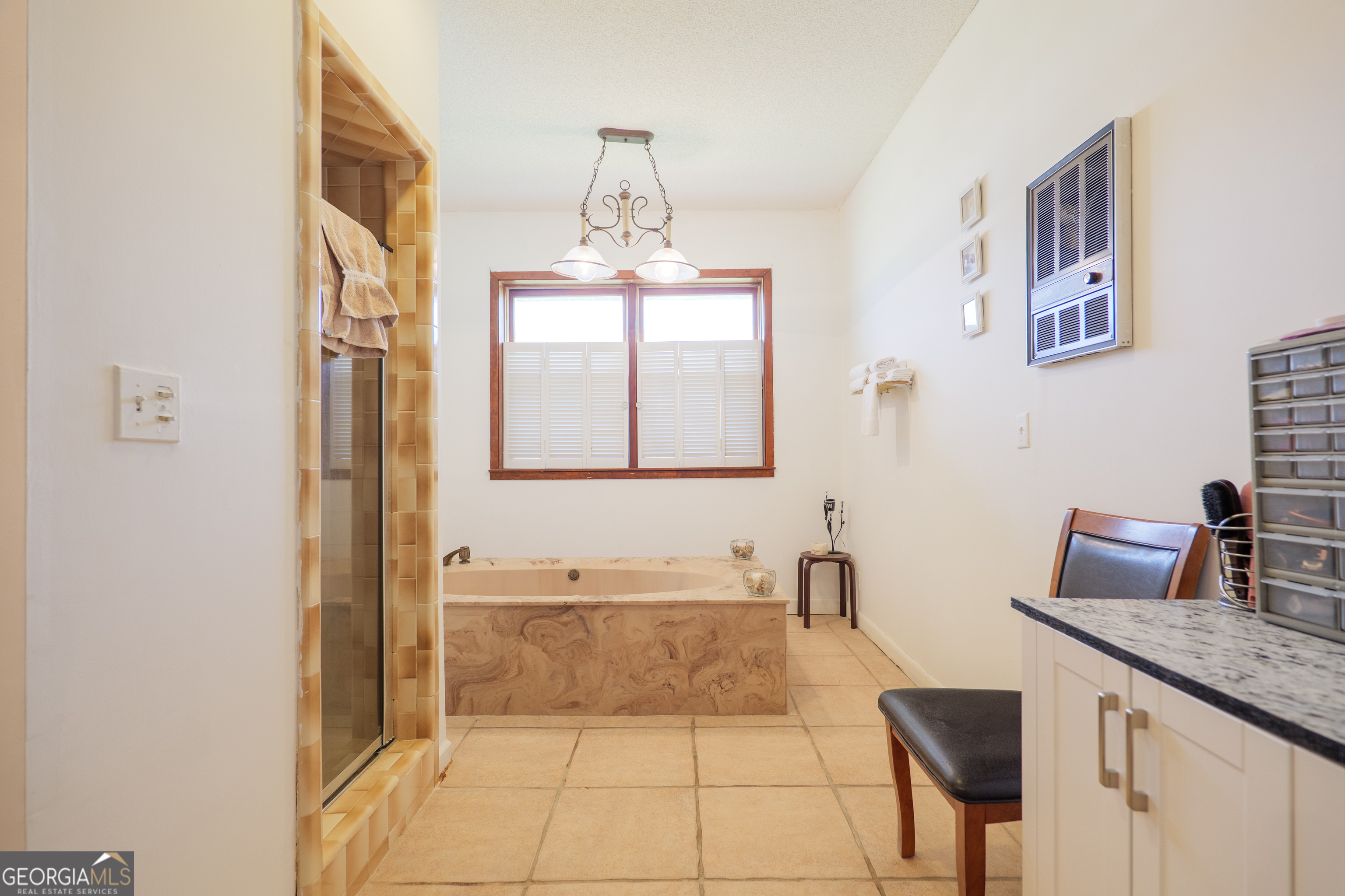 3473 Kay Circle Valdosta, GA 31606 - Photo 42 of 79 a spacious bathroom with a granite countertop sink a mirror and bathtub
