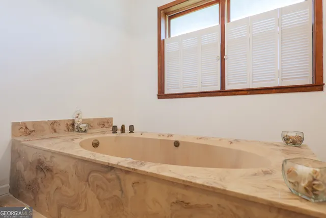 a living room with furniture pool table and a window